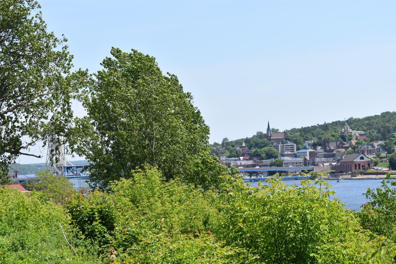 Across the canal to Houghton | State Wide Real Estate of Houghton View across the canal from Hancock to the Houghton hillside, with the lift bridge at the left edge