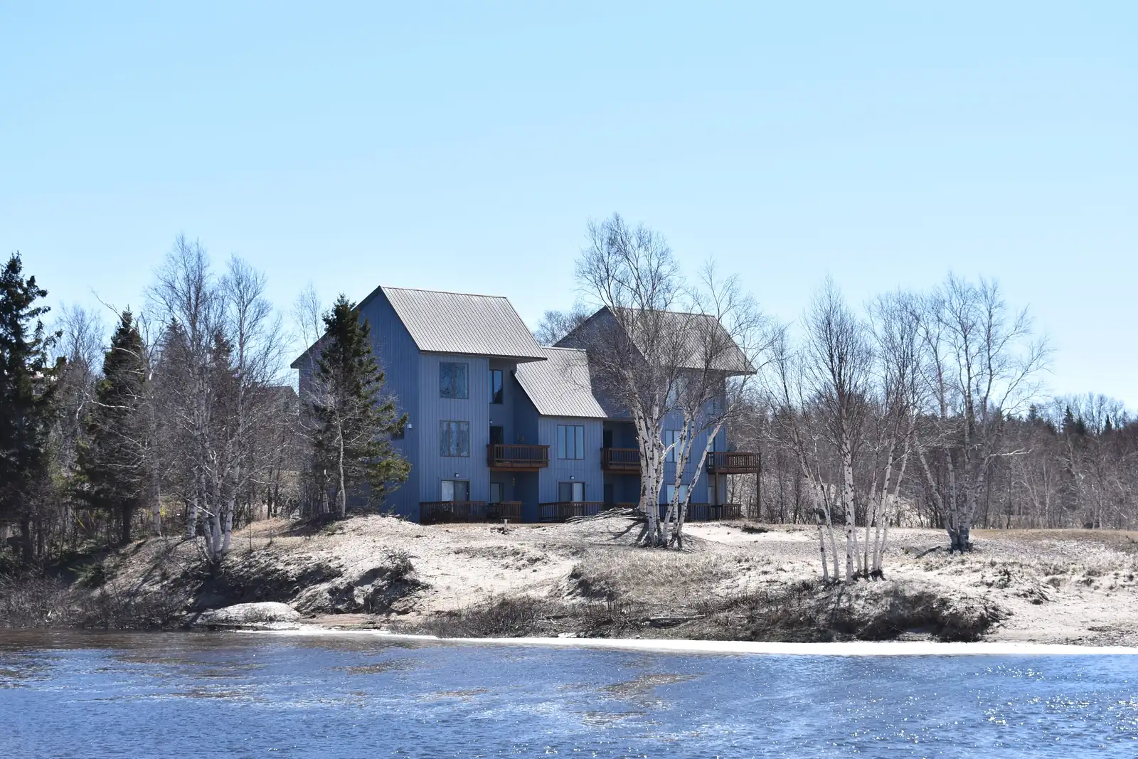 A house on a low sand bluff above the mouth of the Eagle River on Lake Superior.