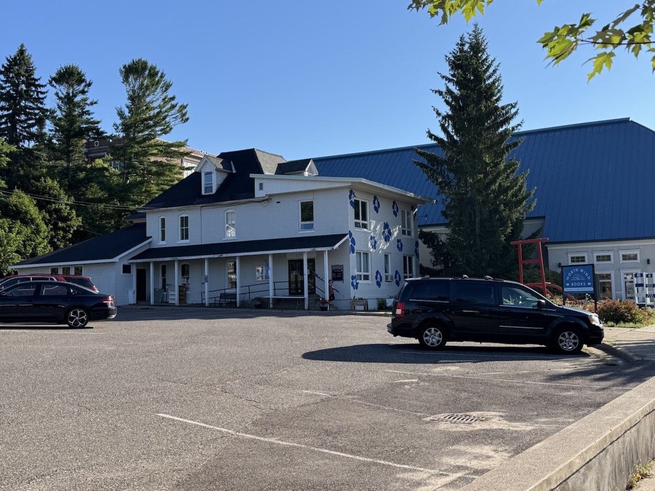 Finnish folk-art building, Hancock MI | State Wide Real Estate of Houghton A white clapboard building in Hancock, Michigan, painted with large blue Finnish folk flowers