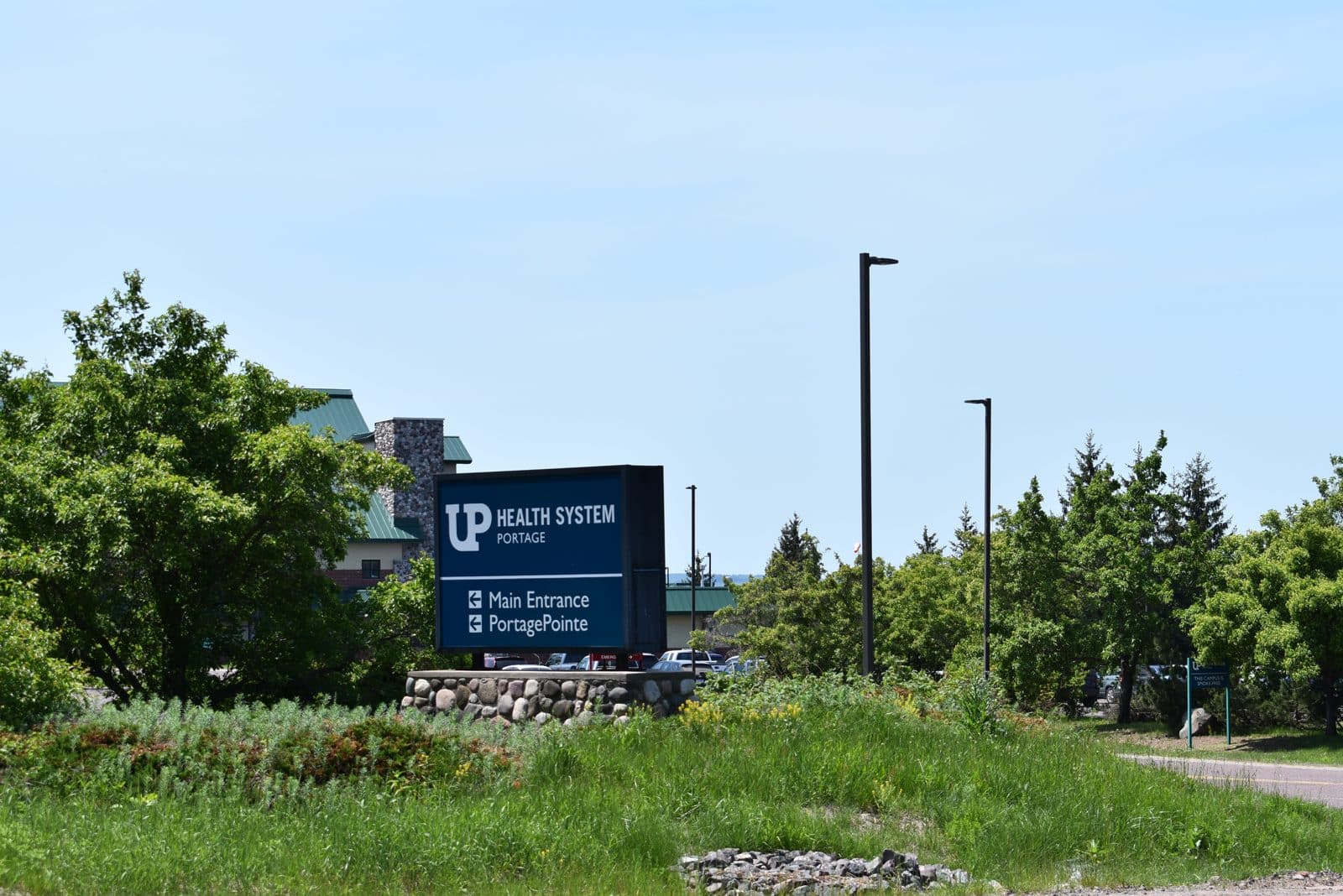 UP Health System Portage, Hancock MI | State Wide Real Estate of Houghton Entrance sign and landscaped drive at UP Health System Portage hospital in Hancock, Michigan