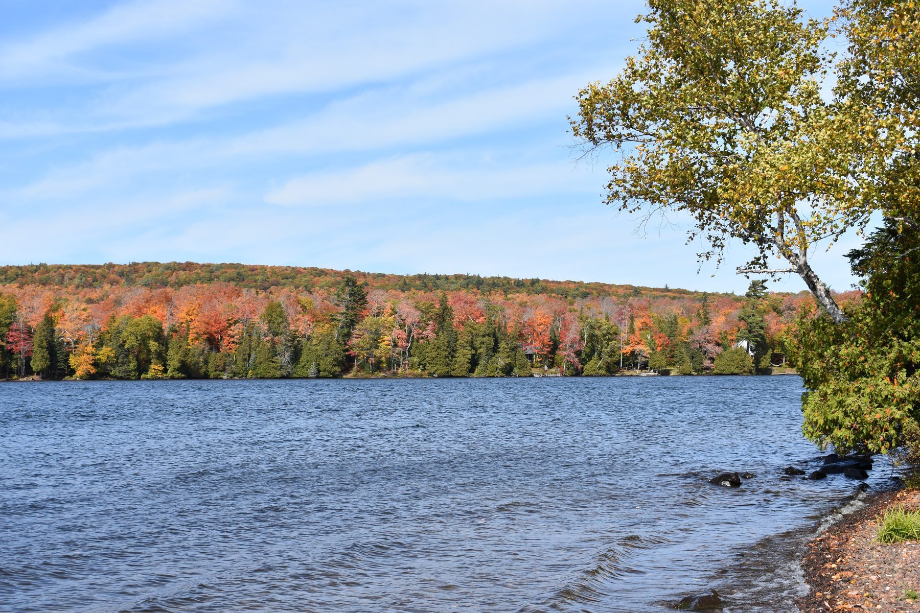 Fall color along a Copper Country shoreline seen across the water