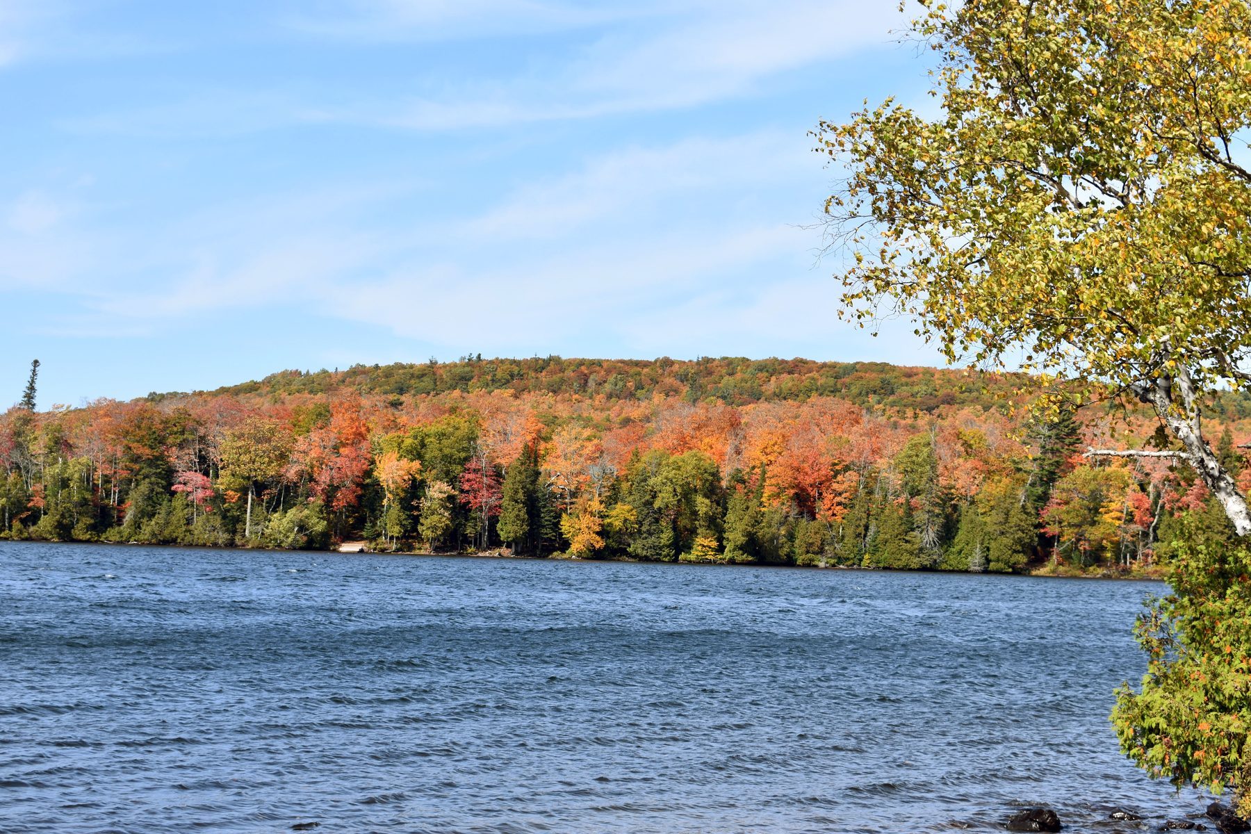A Keweenaw hillside in full fall color above open water