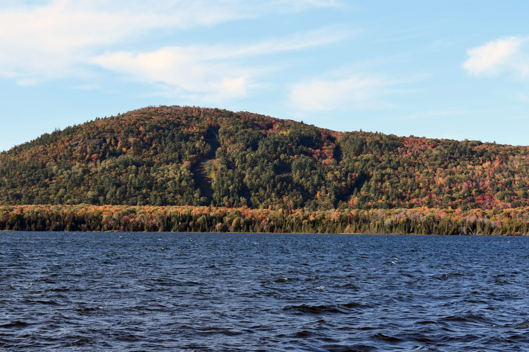 A Keweenaw ridge in fall color seen across open water