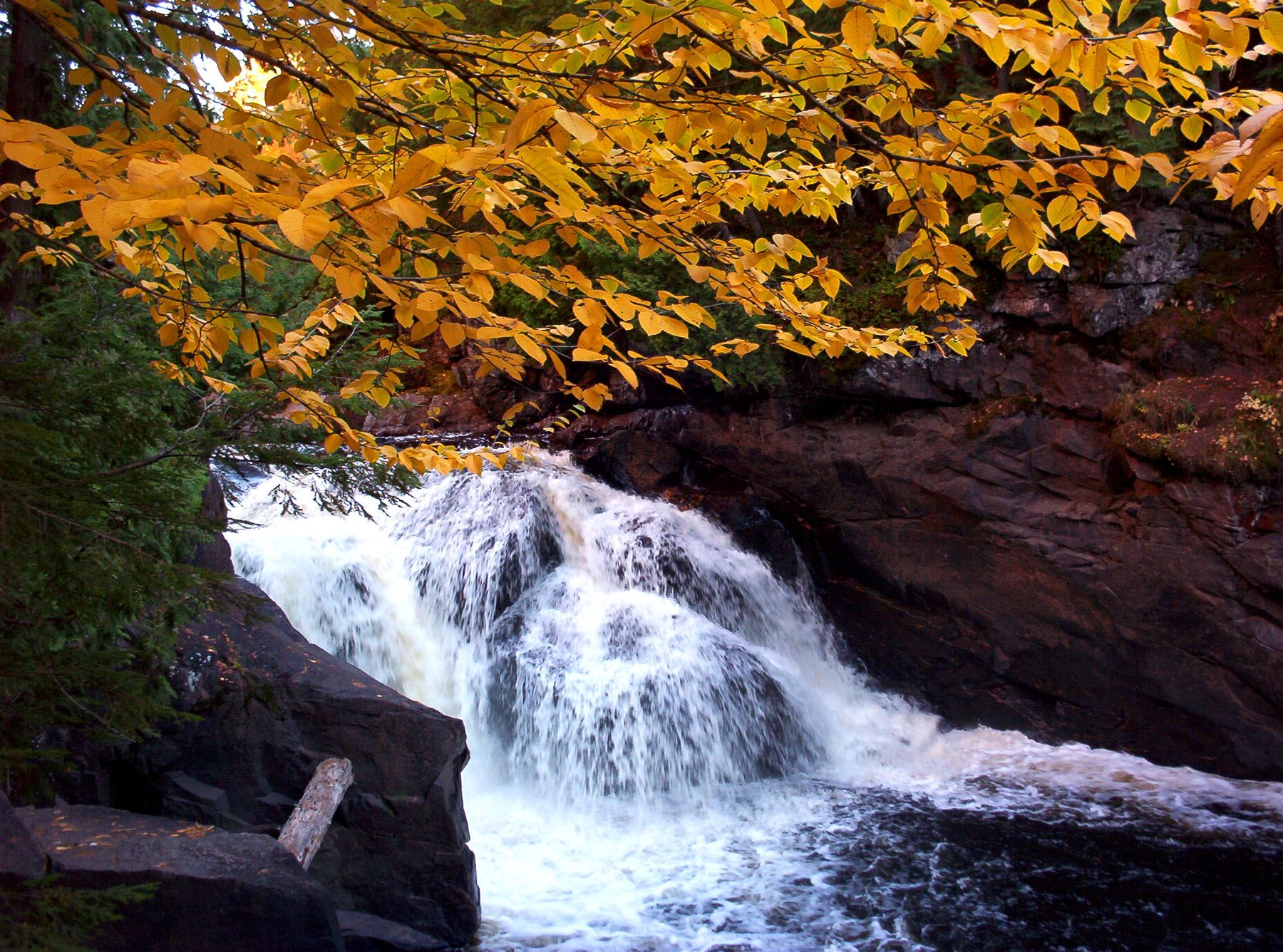 A waterfall in the Sturgeon River Gorge surrounded by fall color